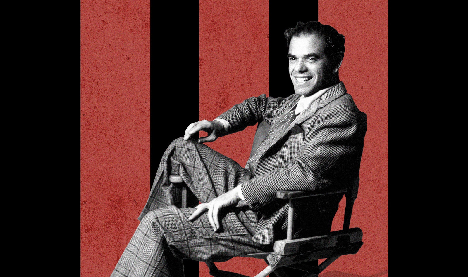 black and white image of a man sitting in a chair with red and black striped background